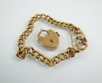 Lot 214 - A yellow metal hollow link bracelet, with bolt...