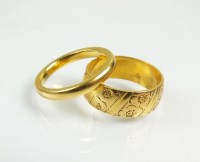 Lot 226 - Two 22ct gold wedding bands, one with engraved...