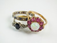 Lot 229 - An opal and ruby cluster ring, designed as a...