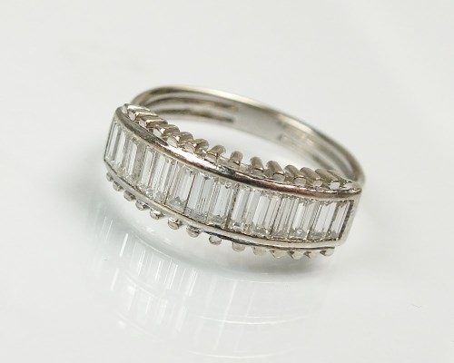 Lot 248 - A baguette cut diamond half hoop eternity ring,...