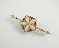 Lot 254 - An opal, diamond and ruby cluster bar brooch,...