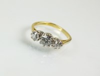 Lot 263 - An 18ct gold three stone diamond ring,...