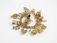 Lot 274 - A 9ct gold charm bracelet, the plain polished...