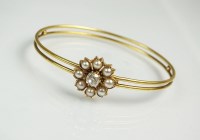 Lot 284 - A late 19th century diamond and pearl bangle,...