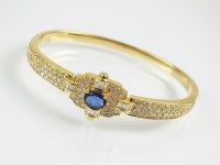 Lot 286 - A sapphire and diamond hinged bangle, designed...