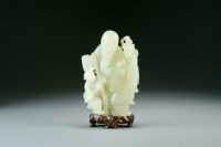Lot 100 - A Chinese greenish white jade figure of an...