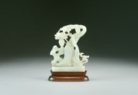 Lot 101 - A Chinese pale green jade figure of Guanyin,...