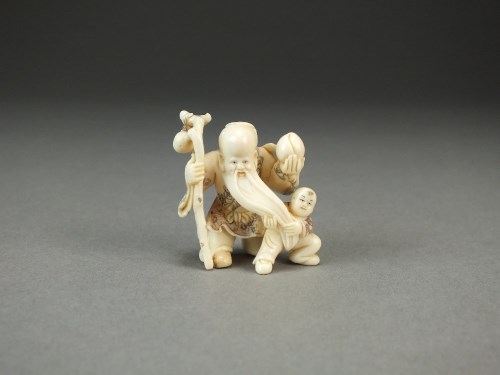 Lot 239 - A Japanese ivory netsuke of Shou Lao, modelled...