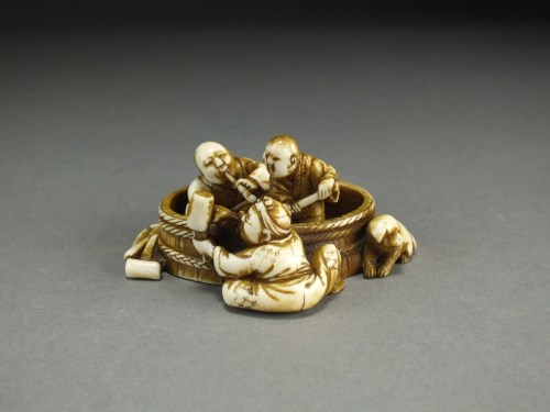 Lot 241 - A Japanese ivory okimono of barrel builders,...