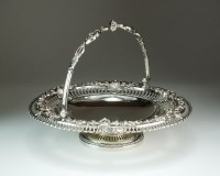 Lot 18 - A Victorian silver swing handled cake basket,...