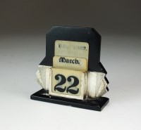 Lot 57 - An Art Deco silver mounted desk calendar, G W...
