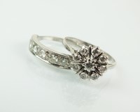 Lot 82 - A seven stone diamond ring, the white metal...