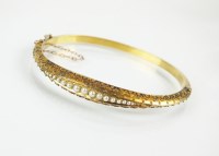 Lot 102 - A late 19th century seed pearl bangle,...