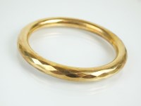 Lot 119 - A 9ct gold faceted hollow bangle, weight 18.5g