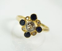 Lot 123 - An 18ct gold diamond and sapphire cluster ring,...