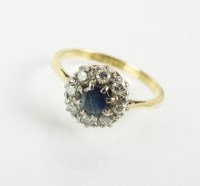 Lot 143 - A sapphire and diamond cluster ring, designed...