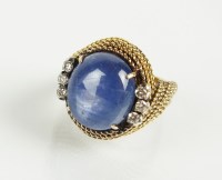 Lot 180 - A star sapphire and diamond dress ring,...