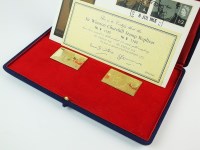 Lot 669 - A cased pair of 18ct gold stamp replicas to...