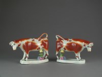 Lot 414 - A pair of Staffordshire milkmaid cow creamers,...