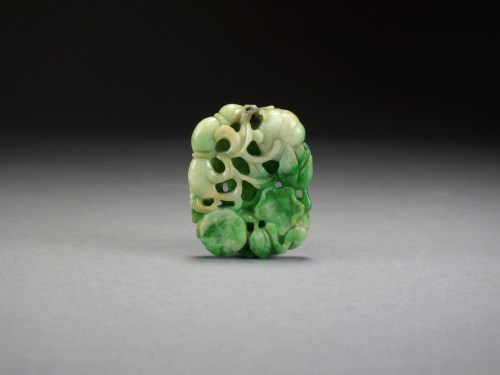 Lot 579 - A Chinese mottled pale green jadeite pendant,...