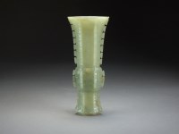 Lot 586 - A Chinese celadon jade archaistic beaker vase,...