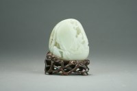 Lot 588 - A Chinese pale celadon jade carving, late Qing...