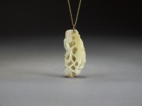 Lot 594 - A Chinese pale green russet veined jade...