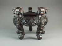 Lot 628 - A large Chinese carved hardwood vase stand,...