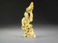 Lot 669 - A Japanese ivory okimono of street...