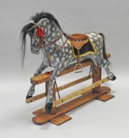 Lot 735 - A dappled grey rocking horse, on a pine swing...