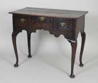 Lot 877 - A mid 18th century oak lowboy the rectangular...