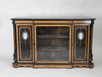 Lot 884 - A Victorian ebonised amboyna banded breakfront...