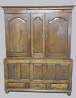 Lot 890 - A George III oak livery cupboard the ogee...