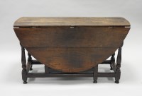 Lot 928 - An early 18th century oak gate-leg dining...