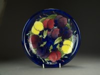 Lot 58 - A Moorcroft plate in the Wisteria pattern...