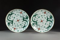 Lot 119 - A pair of Chinese green enamelled dragon...