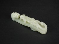 Lot 153 - A Chinese pale greenish-white jade belt hook,...