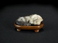 Lot 157 - A Chinese grey jade figure of a recumbent bear,...