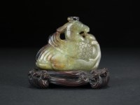 Lot 158 - A Chinese green and russet jade carving of a...