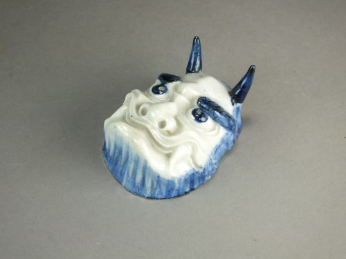 Lot 204 - A Japanese blue and white porcelain oni mask,...