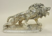 Lot 321 - A modern carved variegated marble lion...