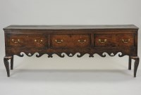Lot 393 - A George III oak three drawer dresser base,...