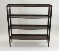 Lot 395 - A rosewood four tier serpentine side shelf, in...
