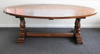 Lot 399 - A large modern oak oval pedestal dining table...