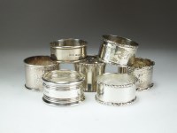 Lot 91 - A collection of seven silver napkin rings,...