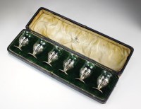 Lot 101 - A cased set of silver mounted tot glasses,...