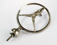 Lot 130 - A white metal Mercedes style car emblem, the...