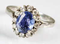 Lot 135 - A sapphire and diamond oval cluster ring,...