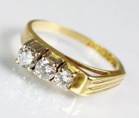 Lot 147 - An 18ct gold three stone diamond ring, the...