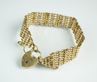 Lot 164 - A 9ct gold seven bar twisted gate link...